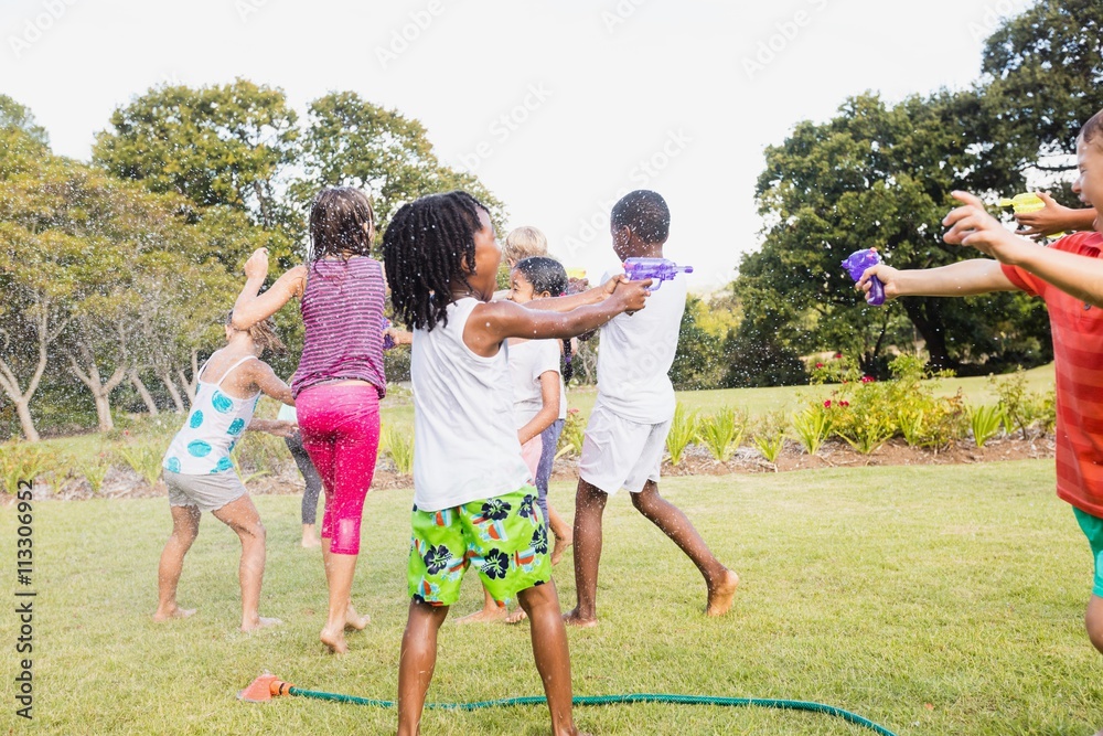 Fototapeta premium Kids playing together during a sunny day