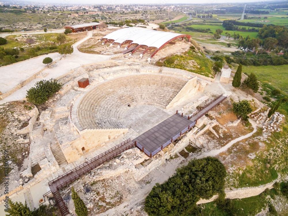 Aerial view of the arcaeological site of the ancient city of Kourio in the district of Limassol, Cyprus. A view from the top of the greek roman theatre forming a semicircle, the beach and fields.