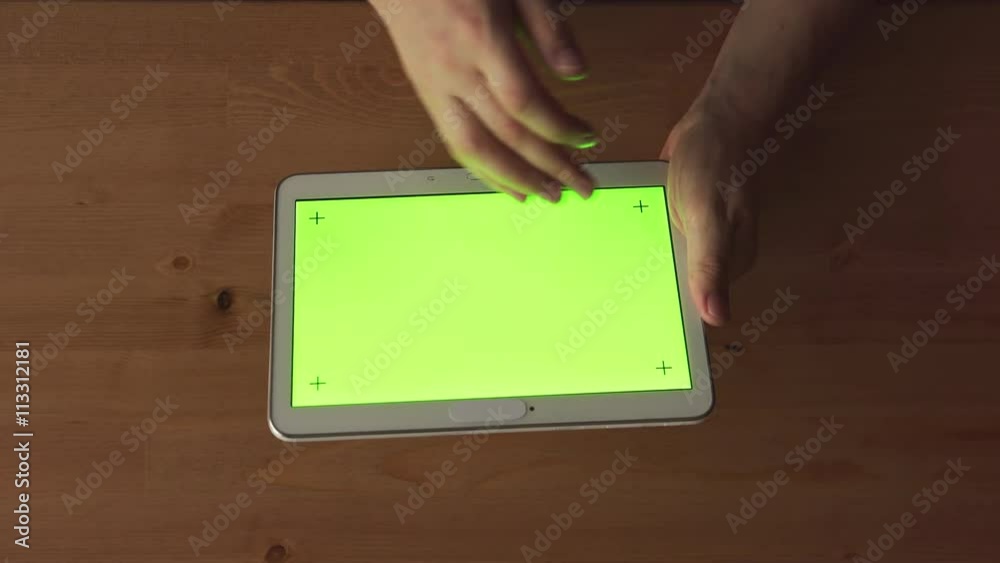 TOP VIEW: Man hands with a tablet PC with green screen TOP VIEW: Man hands with a tablet PC with green screen