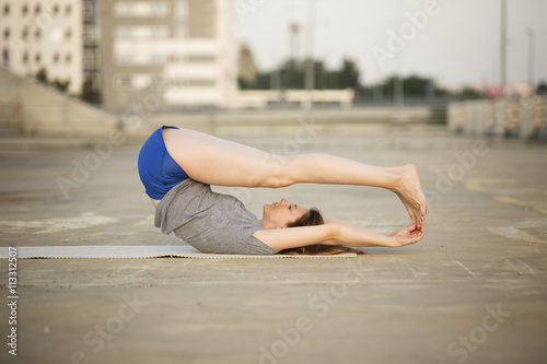 Beautiful woman doing yoga outdoors
