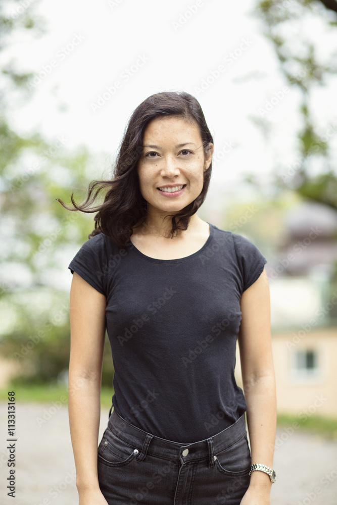 Portrait of smiling woman standing on street Portrait of smiling woman standing on street