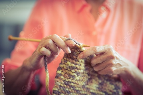 Senior woman knitting wool 