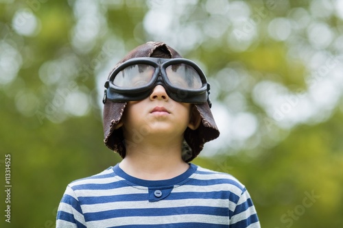 Картината върху платно Boy pretending to be an aviation pilot