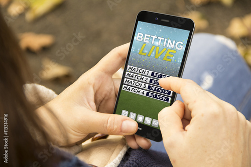 woman with online betting phone in the park