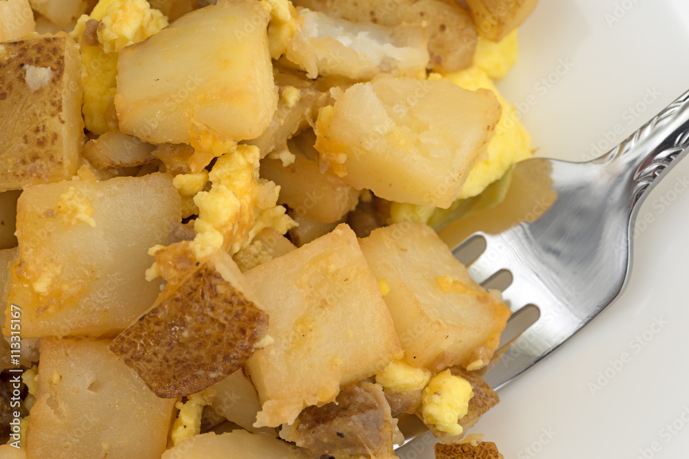 Close view of a breakfast meal with a fork on a plate. Close view of a breakfast meal with a fork on a plate.