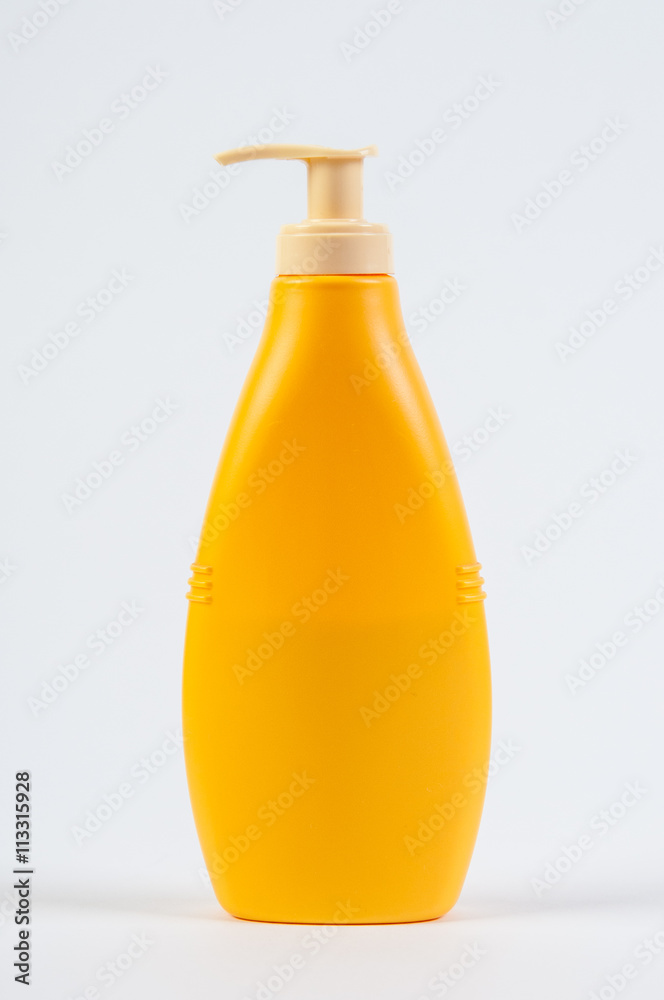 Yellow plastic bottle with cream soap isolated on white background . Studio shooting. Yellow plastic bottle with cream soap isolated on white background . Studio shooting.