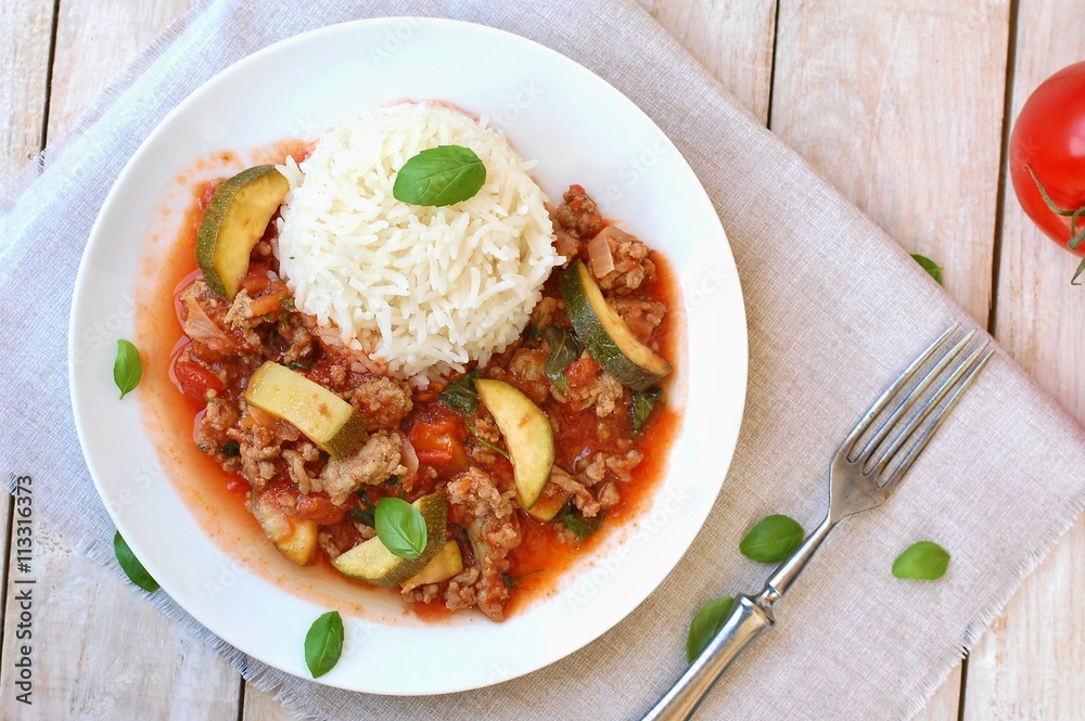 Spicy mincemeat with tomatoes, basil and zucchini with basmati rice