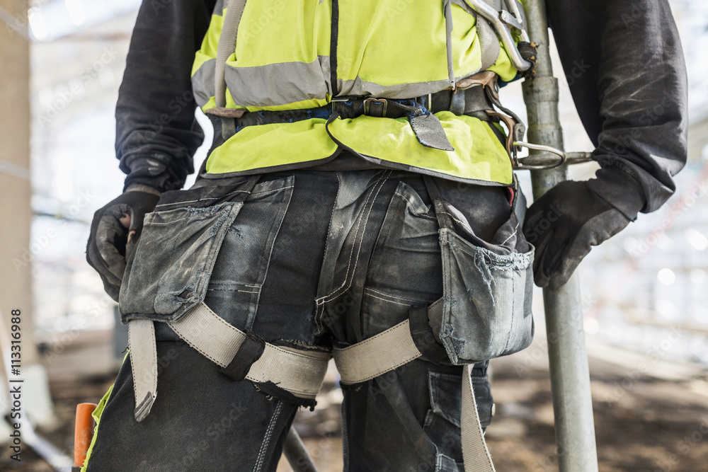Mid section of construction worker Mid section of construction worker