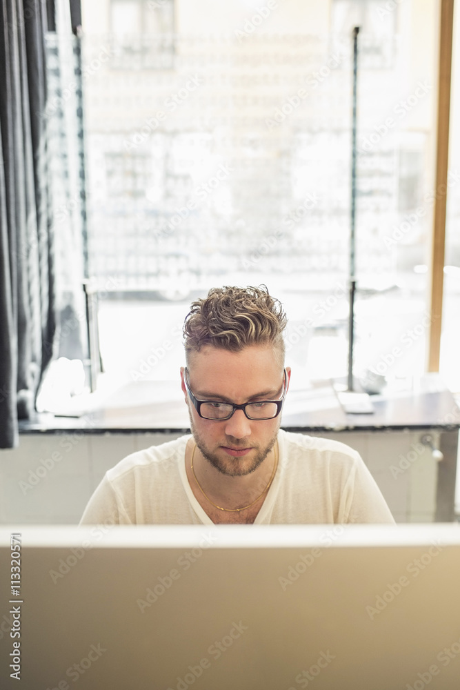 Young businessman using computer in creative office Young businessman using computer in creative office