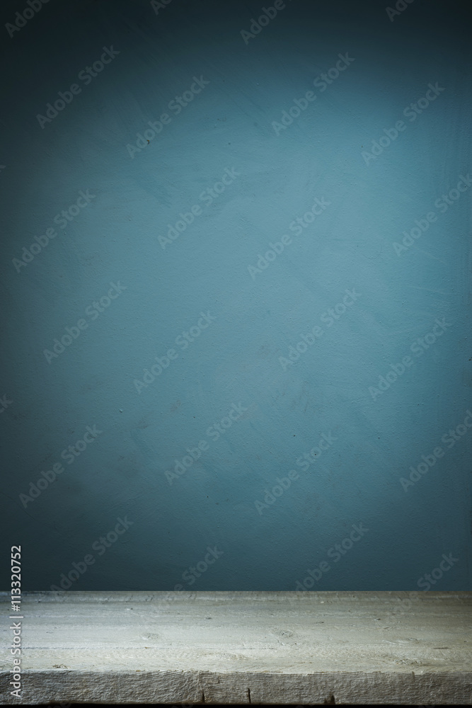 Background with wooden table and grunge blue wall Background with wooden table and grunge blue wall
