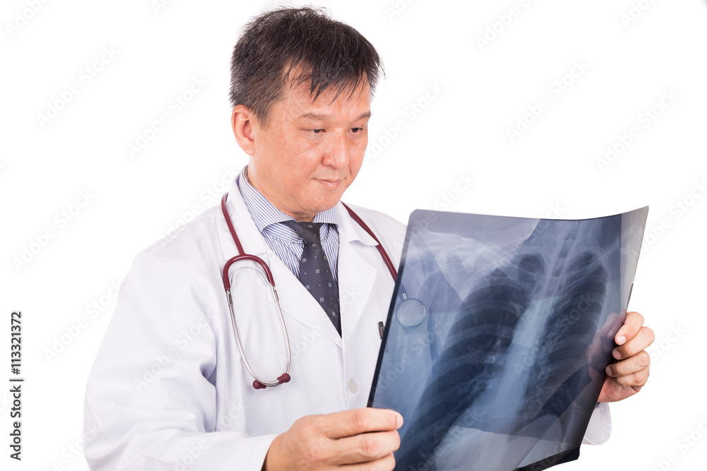 Matured Asian medical doctor examining lungs X-ray negative film Matured Asian medical doctor examining lungs X-ray negative film
