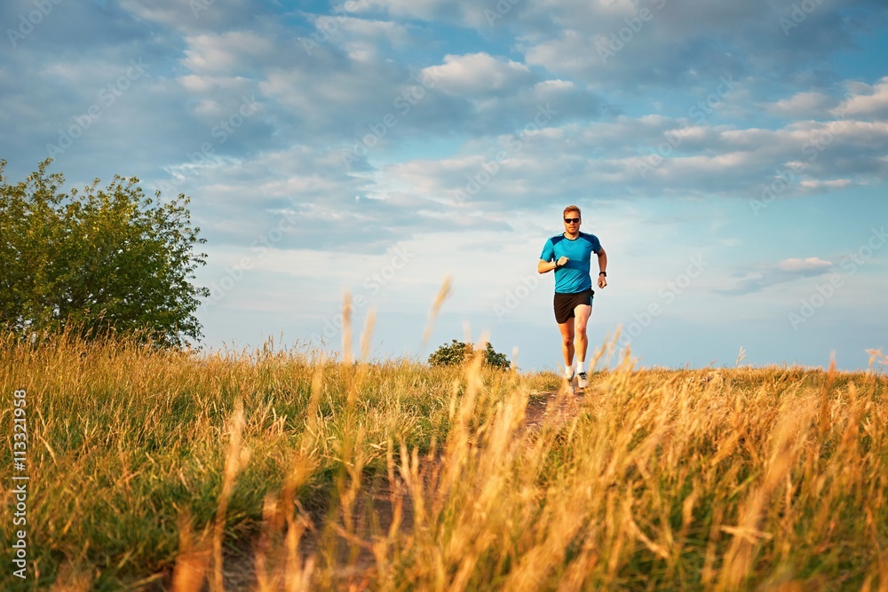 Athletic runner on the hillside