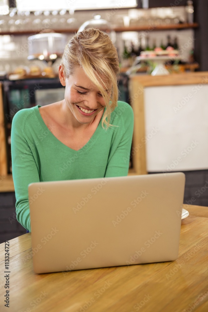 Woman using a laptop sitting Woman using a laptop sitting