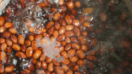 Red kidney beans brewed in boiling water, close-up top view.