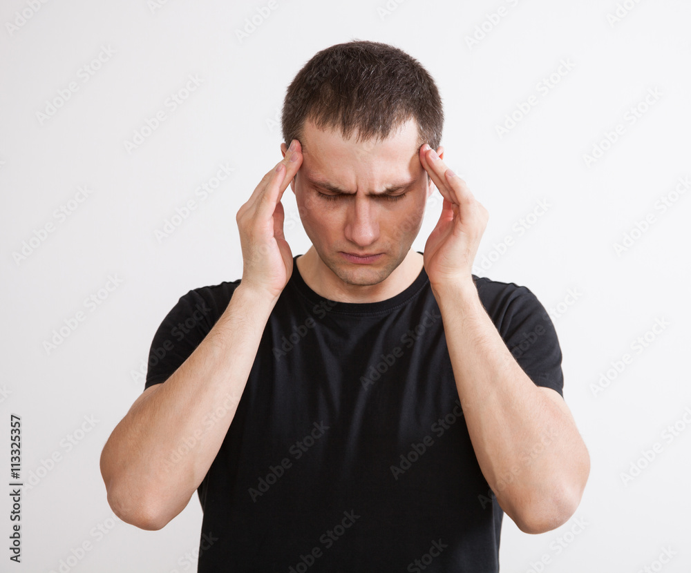 Fototapeta premium Young man touching his temples and remembering something