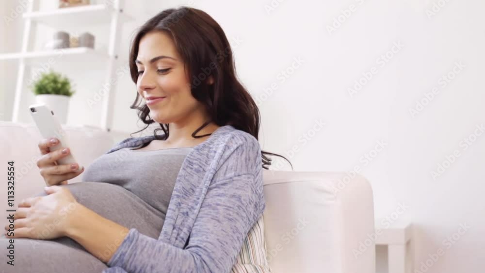 happy pregnant woman with smartphone at home happy pregnant woman with smartphone at home