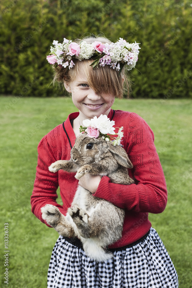 Portrait of girl holding Easter bunny in park Portrait of girl holding Easter bunny in park