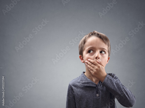 Shocked and surprised child looking into blank space
