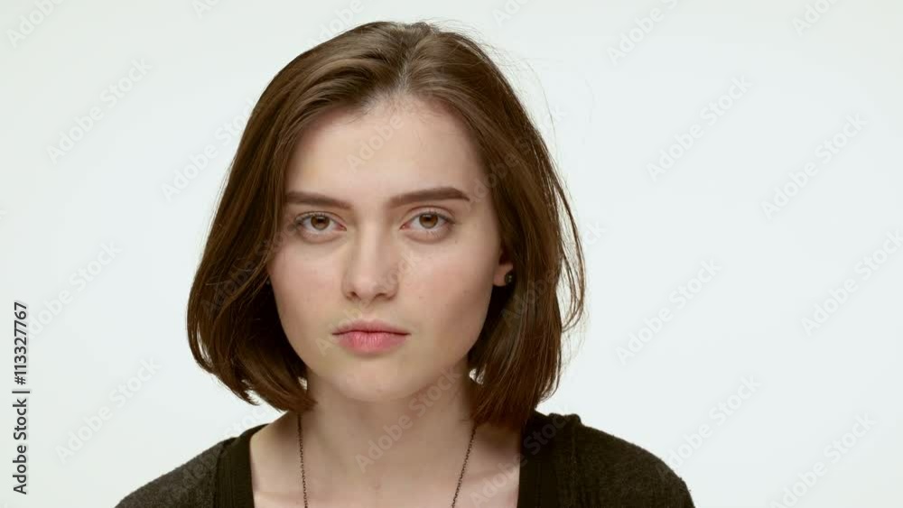 Attractive angry woman staring at you. close up