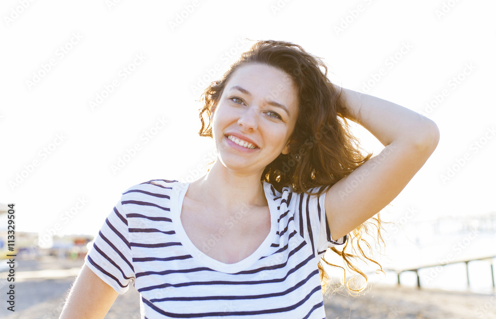 Young woman on the beach in summer