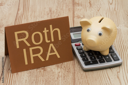 Having a Roth IRA plan, A golden piggy bank, card and calculator