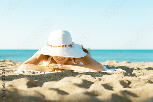 Young woman lying on sandy beach