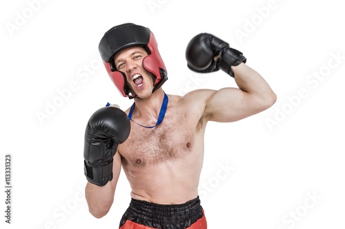 Boxer wearing medal performing boxing stance on white background