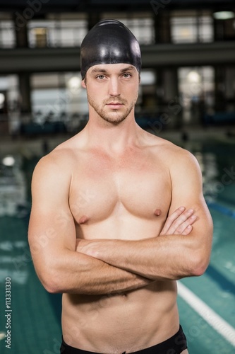 Portrait of swimmer standing by the pool