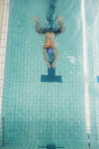Swimmer doing the breaststroke in swimming pool