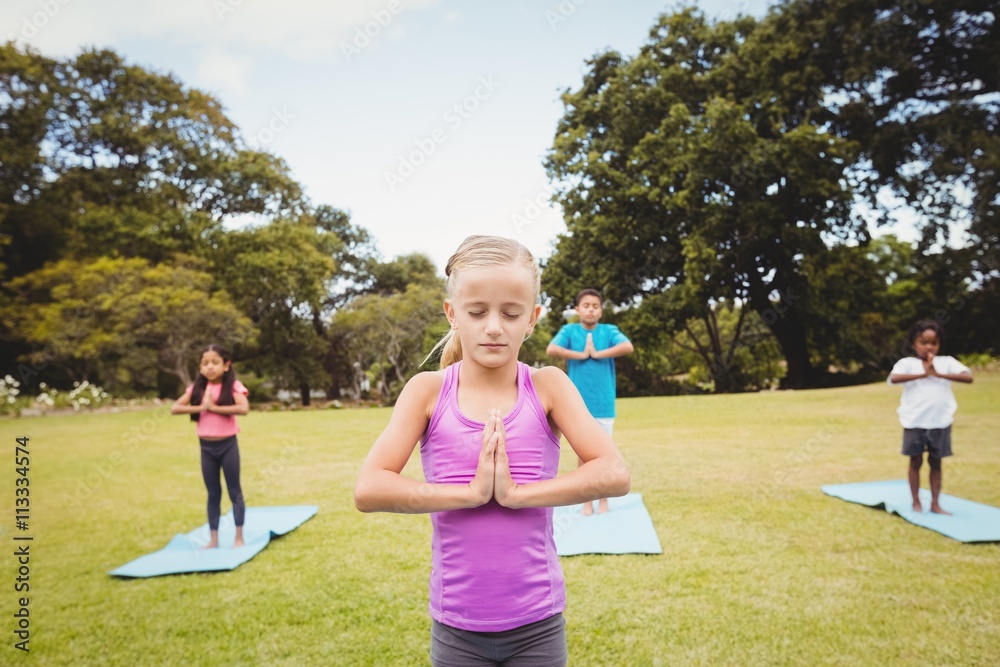 Obraz premium Close up view of girl doing yoga with friends 