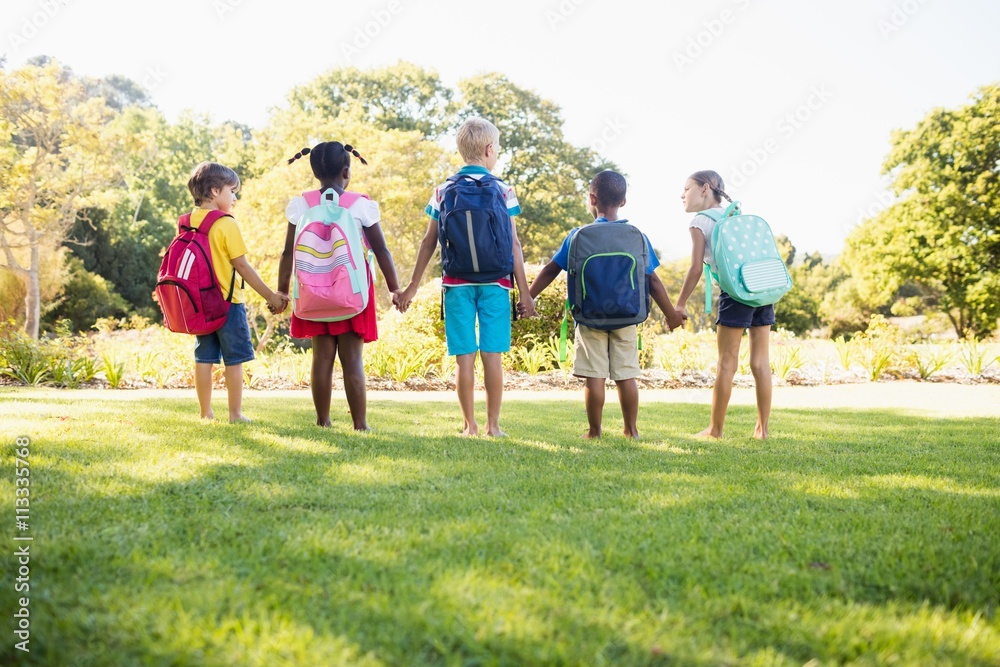 Kids posing together during a sunny day at camera