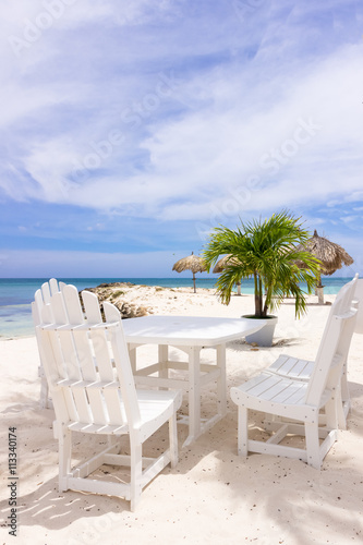 white restaurant table and chairs on the beach
