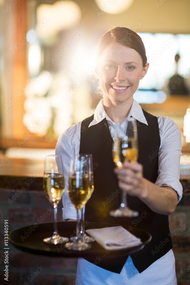 Waitress offering a glass of champagne Waitress offering a glass of champagne