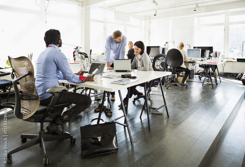 Business people working at desk in office Business people working at desk in office