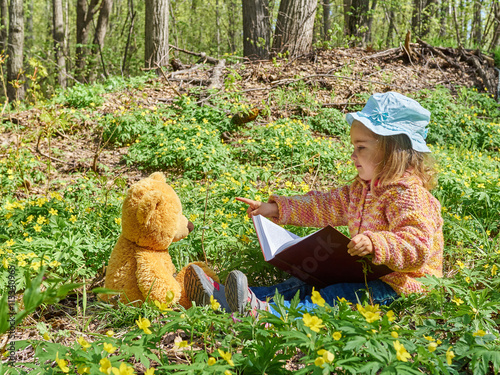 Cute girl reading book Teddy bear