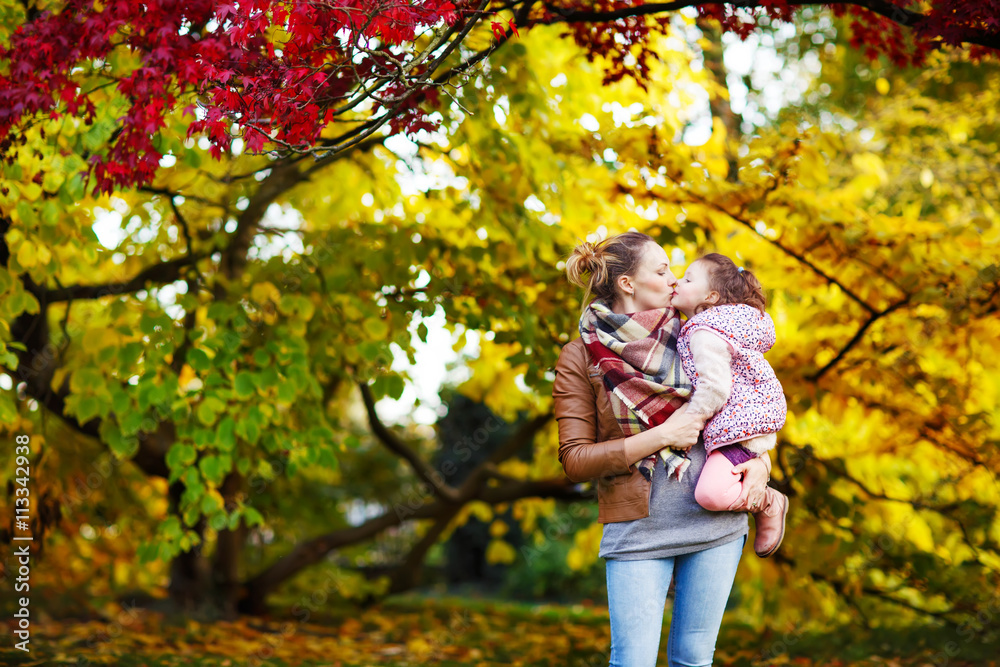 mother and her little daughter at beautiful autumn park mother and her little daughter at beautiful autumn park