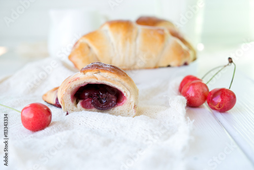 Morning fresh croissants with cherry 