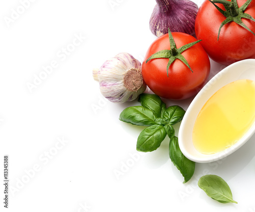 fresh basil, tomatoes and oil on a white background
