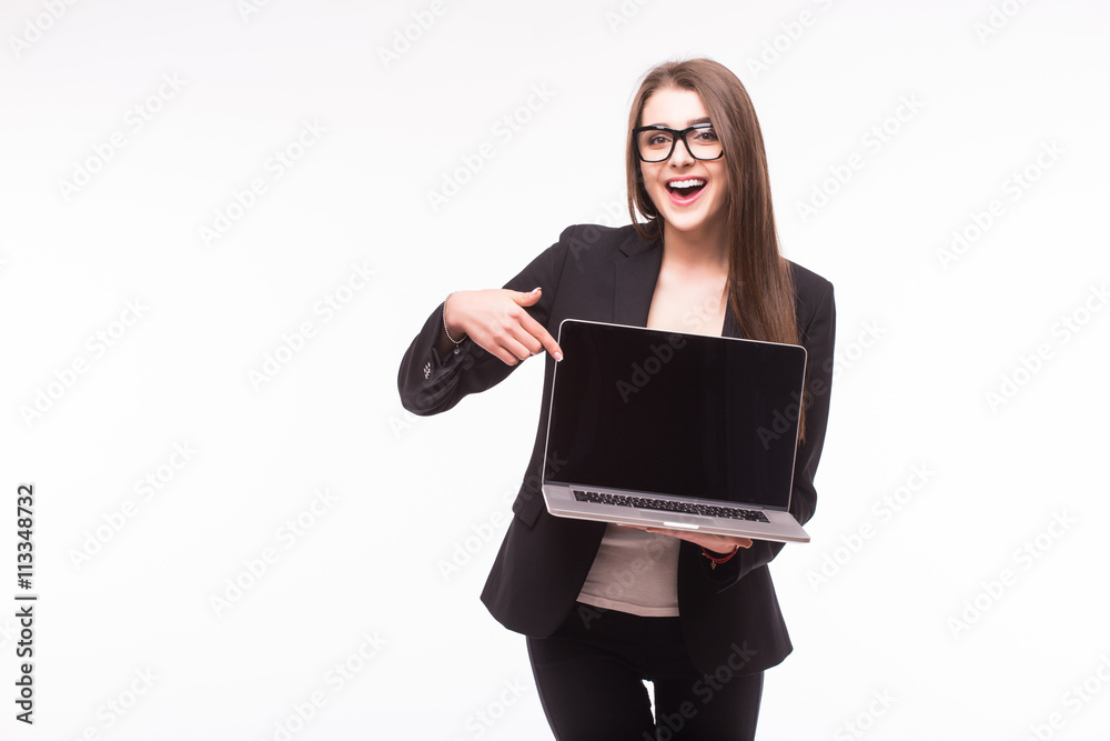 Smiling pretty young woman with friendly happy smile holding a laptop computer and pointing at screen where you add your marketing message Smiling pretty young woman with friendly happy smile holding a laptop computer and pointing at screen where you add your marketing message