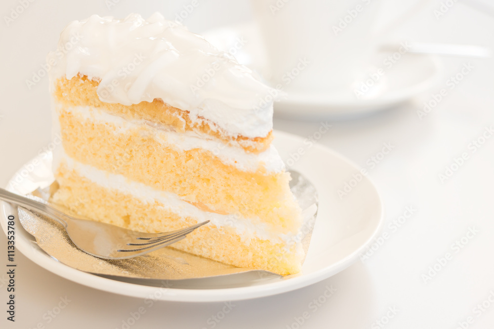Coconut cake in white plate with coffee cup Coconut cake in white plate with coffee cup