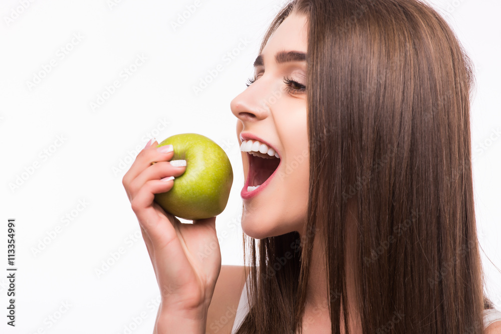 Young girl eat apple. Female teeth and apple. Healthy eating on white background Young girl eat apple. Female teeth and apple. Healthy eating on white background