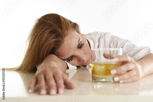 caucasian blond wasted and depressed alcoholic woman drinking scotch whiskey glass messy drunk