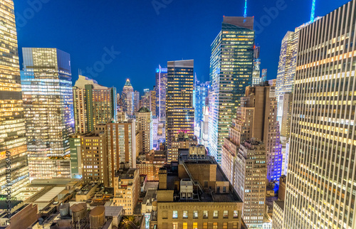 Photography Manhattan skyscrapers at night as seen from New York rooftop