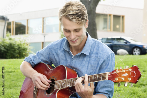 Guy playing guitarr on the break photo