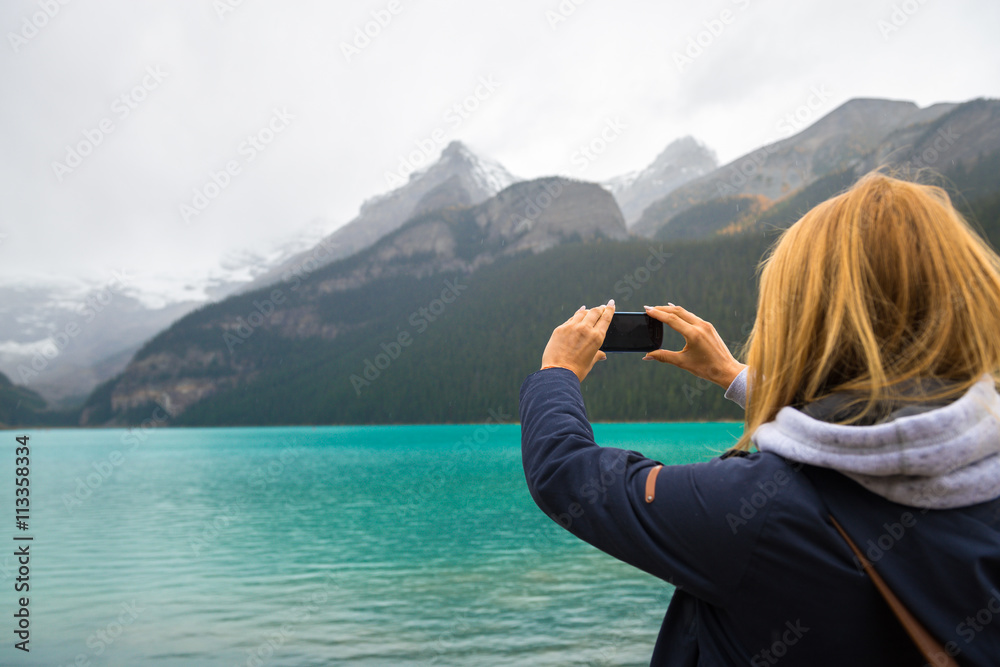 Beautiful girl taking photos in the mountains Beautiful girl taking photos in the mountains