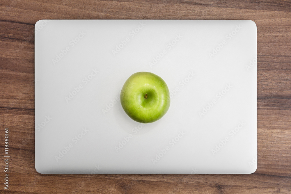 MacBook pro on wooden desk with apple - obrazy, fototapety, plakaty 