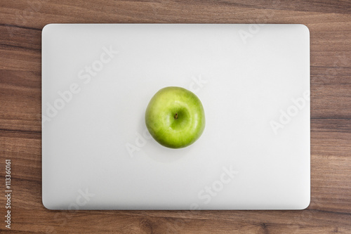 MacBook pro on wooden desk with apple