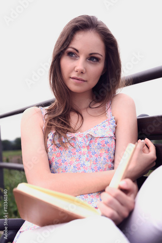 Beautiful Student Girl with Book Daydreaming