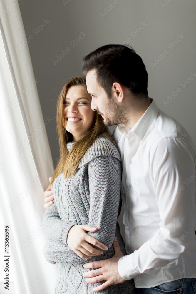 Loving couple by the window