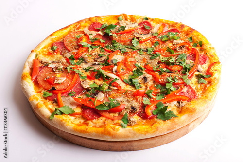 Pizza with salami, tomatoes, paprika and mushrooms isolated on white